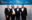 Picture of 4 people in black tie holding up an award